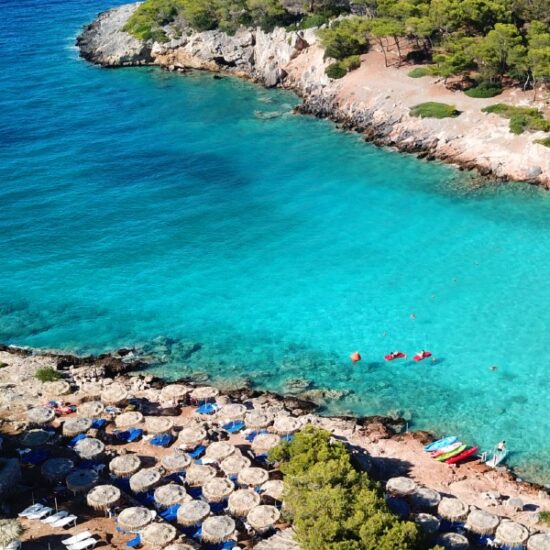 Aponisos beach and lake with clear turquoise waters and pine trees, Agistri island